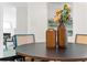 Close up on dining table with decorative vases, hardwood floors, and four chairs in an eat-in kitchen at 2463 Briarmoor Ne Rd, Atlanta, GA 30345