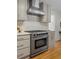 Updated kitchen features stainless steel range hood, white subway tile backsplash, and modern stainless steel range at 2463 Briarmoor Ne Rd, Atlanta, GA 30345