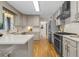 Modern kitchen features stainless steel appliances, light gray cabinets, hardwood floors, and white countertops at 2463 Briarmoor Ne Rd, Atlanta, GA 30345
