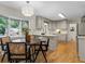 Charming kitchen with light gray cabinets, modern appliances, hardwood floors, and adjacent eat-in area with bay window at 2463 Briarmoor Ne Rd, Atlanta, GA 30345