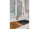 Updated kitchen features a stainless steel kitchen sink with spring faucet and a wooden cutting board at 2463 Briarmoor Ne Rd, Atlanta, GA 30345