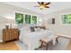 Bedroom with a cozy bed, bench seating, and bright windows overlooking the backyard at 2463 Briarmoor Ne Rd, Atlanta, GA 30345