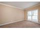 Comfortable bedroom with neutral paint, plush carpet, and a view to the outdoors at 3008 Stockbridge Way, Dacula, GA 30019