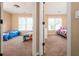 View through doorway of two bedrooms, each with natural light and carpet flooring at 3008 Stockbridge Way, Dacula, GA 30019