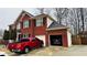 Beautiful two-story brick home with attached garage and well-manicured landscaping at 3008 Stockbridge Way, Dacula, GA 30019