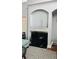 Arched fireplace with decorative woodwork and dark colored backdrop at 3008 Stockbridge Way, Dacula, GA 30019