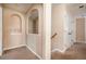 Well-lit hallway featuring carpet flooring, archway, and neutral walls at 3008 Stockbridge Way, Dacula, GA 30019