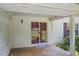 Covered back patio featuring a brick wall, sliding glass doors, and outdoor lighting at 4389 Hambrick Way, Stone Mountain, GA 30083