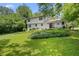 Expansive backyard with lush greenery and a charming two-story home in a serene setting at 4389 Hambrick Way, Stone Mountain, GA 30083