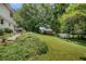 Expansive backyard with a shed, well-maintained lawn, and glimpses of the house's back exterior at 4389 Hambrick Way, Stone Mountain, GA 30083