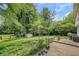 Lush backyard featuring mature trees, a patio area, and ample space for outdoor activities at 4389 Hambrick Way, Stone Mountain, GA 30083