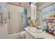 This bathroom features a shower with blue curtain, a toilet, and a vanity with a mirror at 4389 Hambrick Way, Stone Mountain, GA 30083