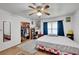 Bedroom with closet, fan, desk, and queen bed featuring colorful bedspread at 4389 Hambrick Way, Stone Mountain, GA 30083