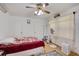 Bright bedroom features a floral-patterned bedspread, a ceiling fan and two closets with white doors at 4389 Hambrick Way, Stone Mountain, GA 30083