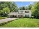 Charming two-story home features a brick exterior, a basketball hoop, and a large, well-manicured front lawn at 4389 Hambrick Way, Stone Mountain, GA 30083