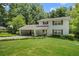 Charming two-story home boasts manicured lawn, covered parking, and mature trees at 4389 Hambrick Way, Stone Mountain, GA 30083