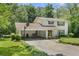 Charming two-story home boasts manicured lawn, covered parking, and mature trees at 4389 Hambrick Way, Stone Mountain, GA 30083