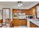 Functional kitchen featuring wooden cabinetry, white countertops, and a dining area at 4389 Hambrick Way, Stone Mountain, GA 30083
