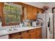 Well-maintained kitchen featuring a stainless steel refrigerator, a window view, and ample counter space at 4389 Hambrick Way, Stone Mountain, GA 30083
