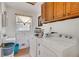 Functional laundry room with a washer, dryer, sink, and storage cabinets, ideal for household chores at 4389 Hambrick Way, Stone Mountain, GA 30083
