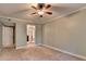 Neutral bedroom with tan carpet, ceiling fan, and mirrored closet at 1010 Donegal Se, Smyrna, GA 30080