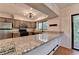View of the kitchen with granite countertops, stainless appliances, and an eat-in dining area at 1010 Donegal Se, Smyrna, GA 30080