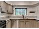 Updated kitchen featuring stainless appliances, gray cabinets, granite countertops, and new flooring at 1010 Donegal Se, Smyrna, GA 30080