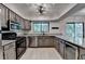 An elegant kitchen with granite countertops, stainless steel appliances, and a view to a treed backyard at 1010 Donegal Se, Smyrna, GA 30080