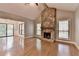 Bright living room featuring hardwood floors, stone fireplace, and sliding doors to outdoor space at 1010 Donegal Se, Smyrna, GA 30080