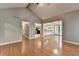 Open living room with vaulted ceiling, hardwood floors, and views of the kitchen and hallway at 1010 Donegal Se, Smyrna, GA 30080