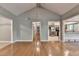 Bright living room showcasing hardwood floors, open layout, and access to the kitchen and hallway at 1010 Donegal Se, Smyrna, GA 30080