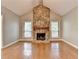 Open living room with vaulted ceilings, stone fireplace, hardwood floors, and ample natural light at 1010 Donegal Se, Smyrna, GA 30080