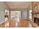 Spacious living room with hardwood floors, stone fireplace, open floor plan, and access to kitchen at 1010 Donegal Se, Smyrna, GA 30080