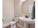 Elegant half-bathroom featuring modern fixtures, a pedestal sink, and classic design at 1104 Knoxboro Ln, Woodstock, GA 30188