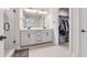 Bright bathroom featuring a double vanity, framed mirrors, matte black fixtures, and walk-in closet at 1104 Knoxboro Ln, Woodstock, GA 30188