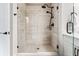 Shower stall featuring tiled walls, matte black shower head, handheld sprayer, and glass doors at 1104 Knoxboro Ln, Woodstock, GA 30188