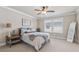 Bright bedroom featuring a large bed, soft lighting, and a window for natural light at 1104 Knoxboro Ln, Woodstock, GA 30188