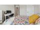Bright bedroom featuring a floral print bedspread, a desk, and beige carpet at 1104 Knoxboro Ln, Woodstock, GA 30188