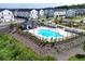 Aerial view of community pool and amenity center in a modern townhome neighborhood at 1104 Knoxboro Ln, Woodstock, GA 30188