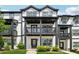 Charming townhome with a covered porch and classic black-and-white trim offers inviting curb appeal at 1104 Knoxboro Ln, Woodstock, GA 30188