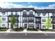Attractive row of townhomes in a modern style, showing landscaping and exterior details on a sunny day at 1104 Knoxboro Ln, Woodstock, GA 30188
