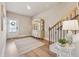 Bright foyer with hardwood floors, staircase, and a view of the front door and entry way at 1104 Knoxboro Ln, Woodstock, GA 30188