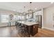 Modern kitchen featuring a large island with seating, stainless steel appliances, and stylish pendant lights at 1104 Knoxboro Ln, Woodstock, GA 30188