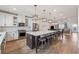 Open kitchen showcasing a large island, stainless appliances, white cabinetry, and seamless flow to living spaces at 1104 Knoxboro Ln, Woodstock, GA 30188