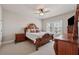 Cozy primary bedroom with plush carpeting, ceiling fan, and a relaxing atmosphere at 1104 Knoxboro Ln, Woodstock, GA 30188