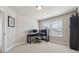 Bright office featuring two computer setups, office chair, beige carpet, and built in bookcase at 1104 Knoxboro Ln, Woodstock, GA 30188