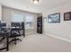 Bright room featuring a desk, office chair, beige carpet, and built in bookcase at 1104 Knoxboro Ln, Woodstock, GA 30188