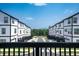 Exterior view showing the street with townhomes and garages on each side at 1104 Knoxboro Ln, Woodstock, GA 30188