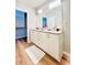 Bathroom features granite countertops, double sinks, and leads to a walk-in closet with built-in shelving at 400 W Peachtree Nw St # 2704, Atlanta, GA 30308