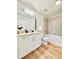 Well lit bathroom features granite countertops, single sink, tub/shower, and white cabinets at 400 W Peachtree Nw St # 2704, Atlanta, GA 30308